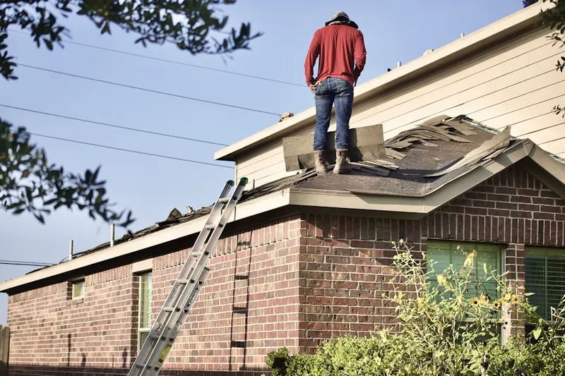 Professional roofer working on a residential roof in Starford